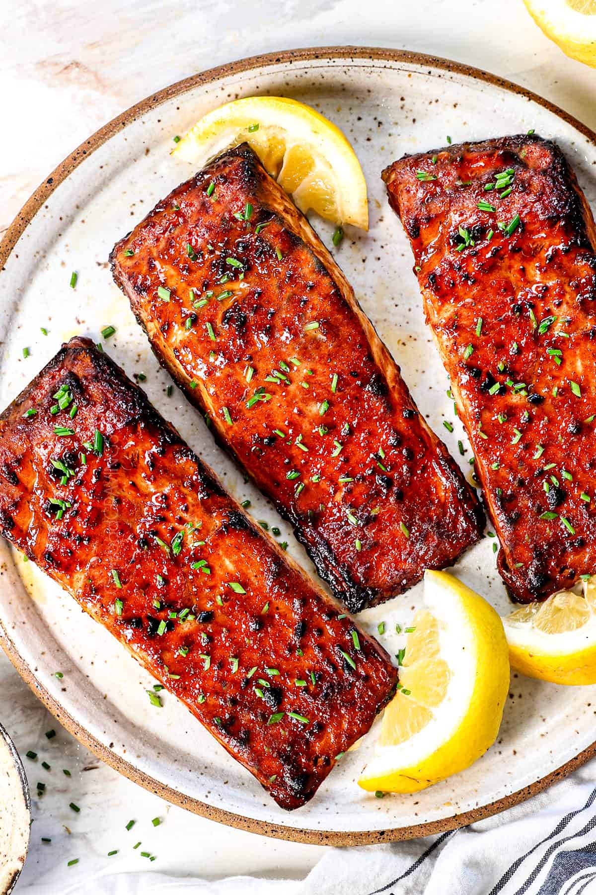 air fry salmon on a plate being served with lemon