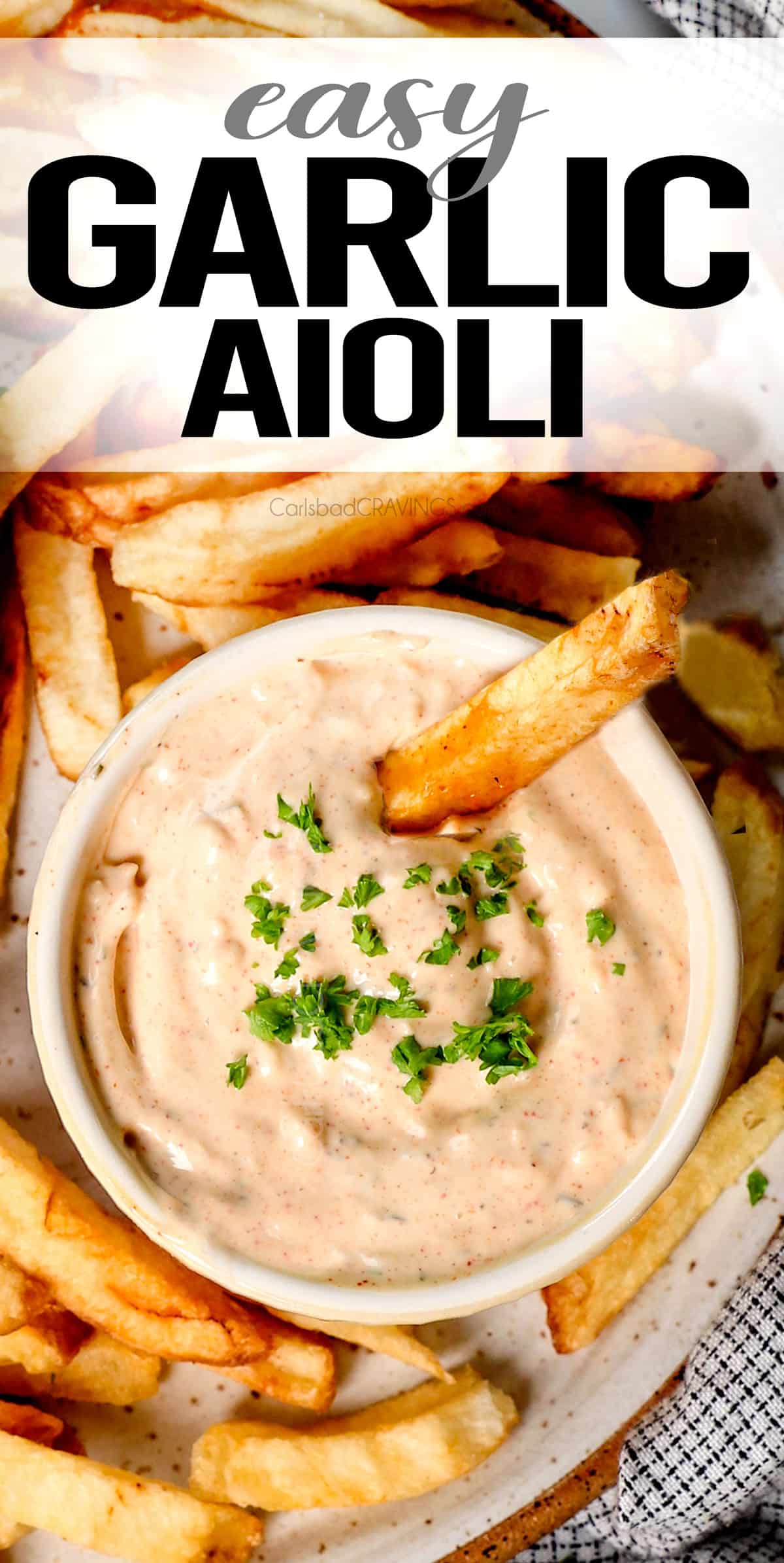 top view of garlic aioli in a bowl garnished with parsley