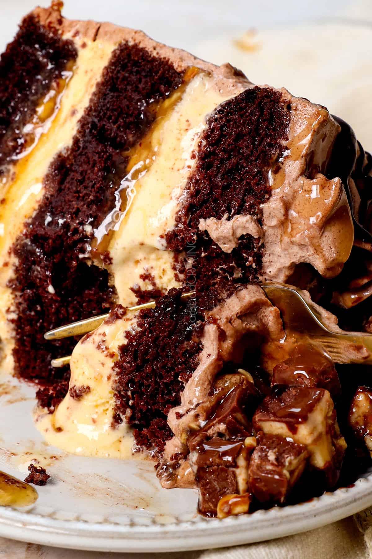 up close of ice cream cake recipe with a bite take out showing how moist the cake is and soft the ice cream is