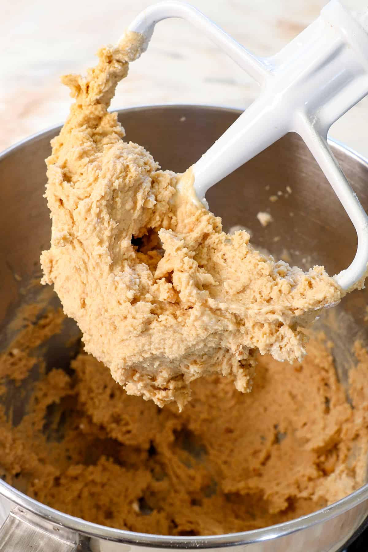showing how to make edible cookie dough lifting the paddle attachment to show the consistency of the dough