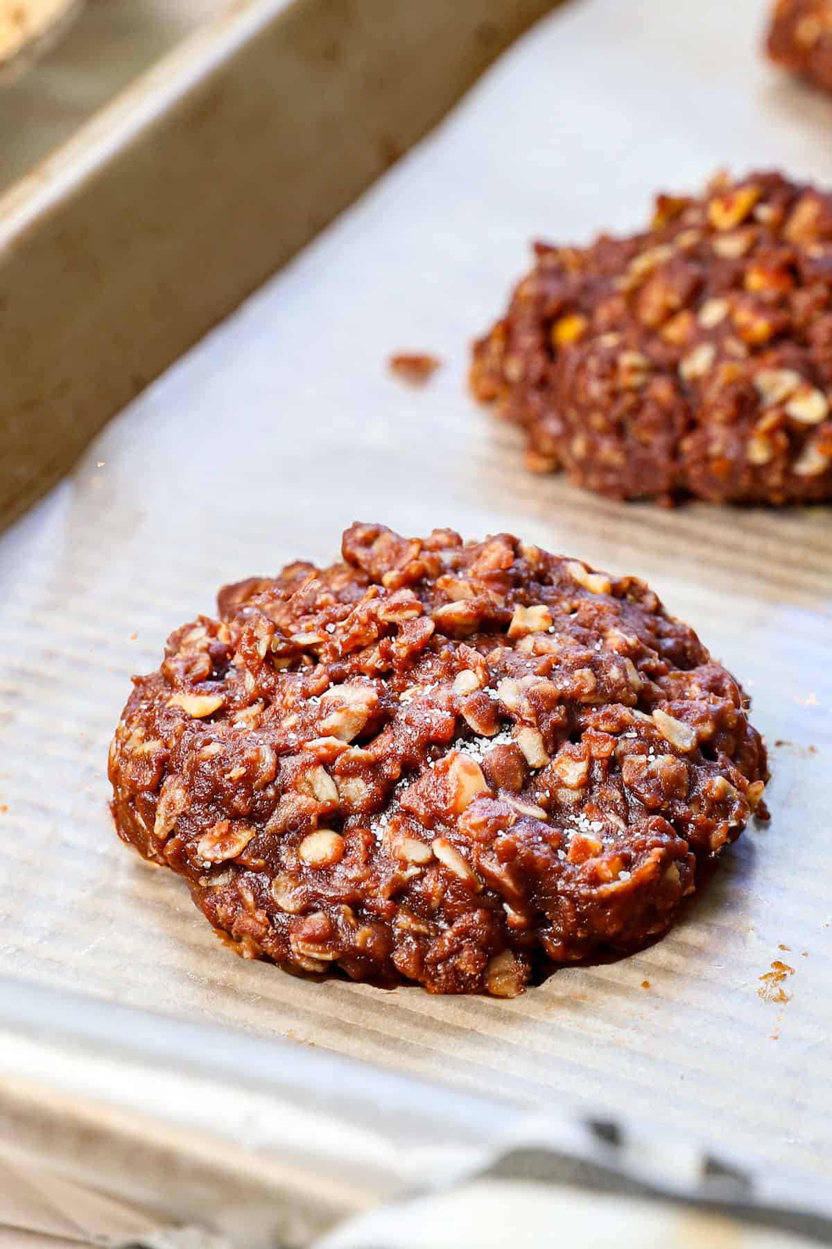 up close of no bake chocolate oatmeal cookies on a baking sheet while they set