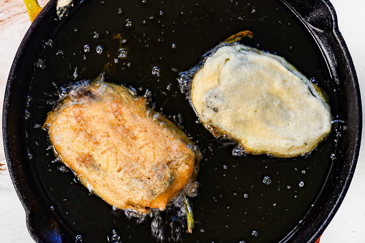showing how to make chile rellenos by frying in hot oil until golden