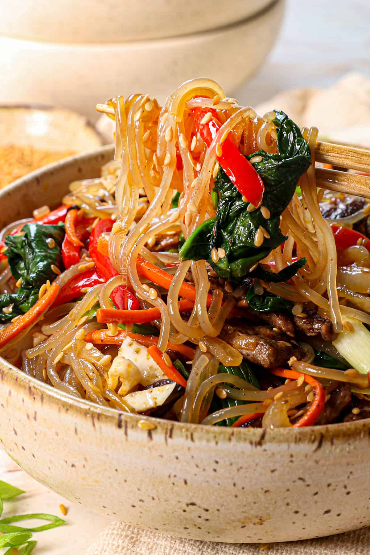 picking up noodles with chopsticks of the best japchae recipe