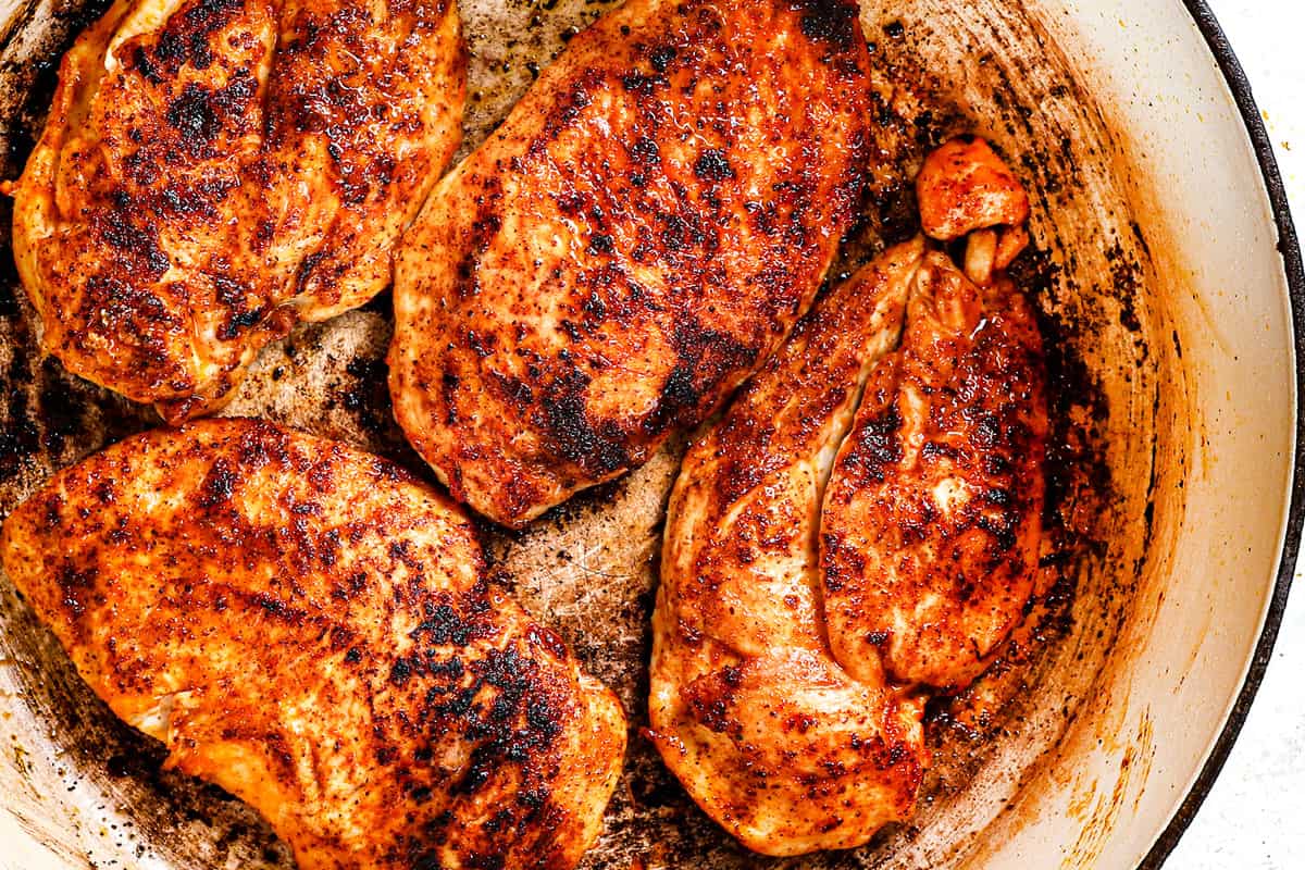 showing how to make Marry Me Chicken by cooking the chicken until seared and cooked through