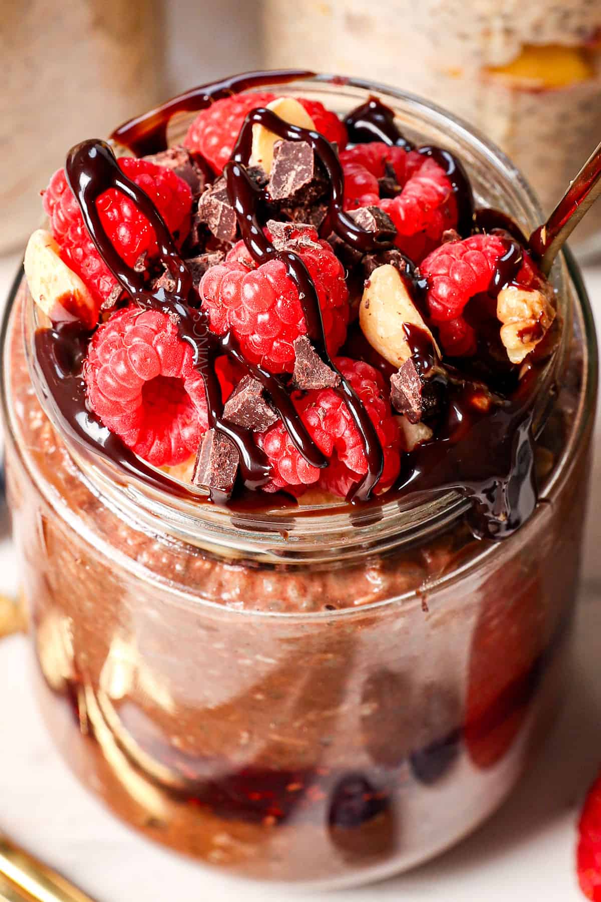 up close of best overnight oats recipe showing how to garnish with berries and nut