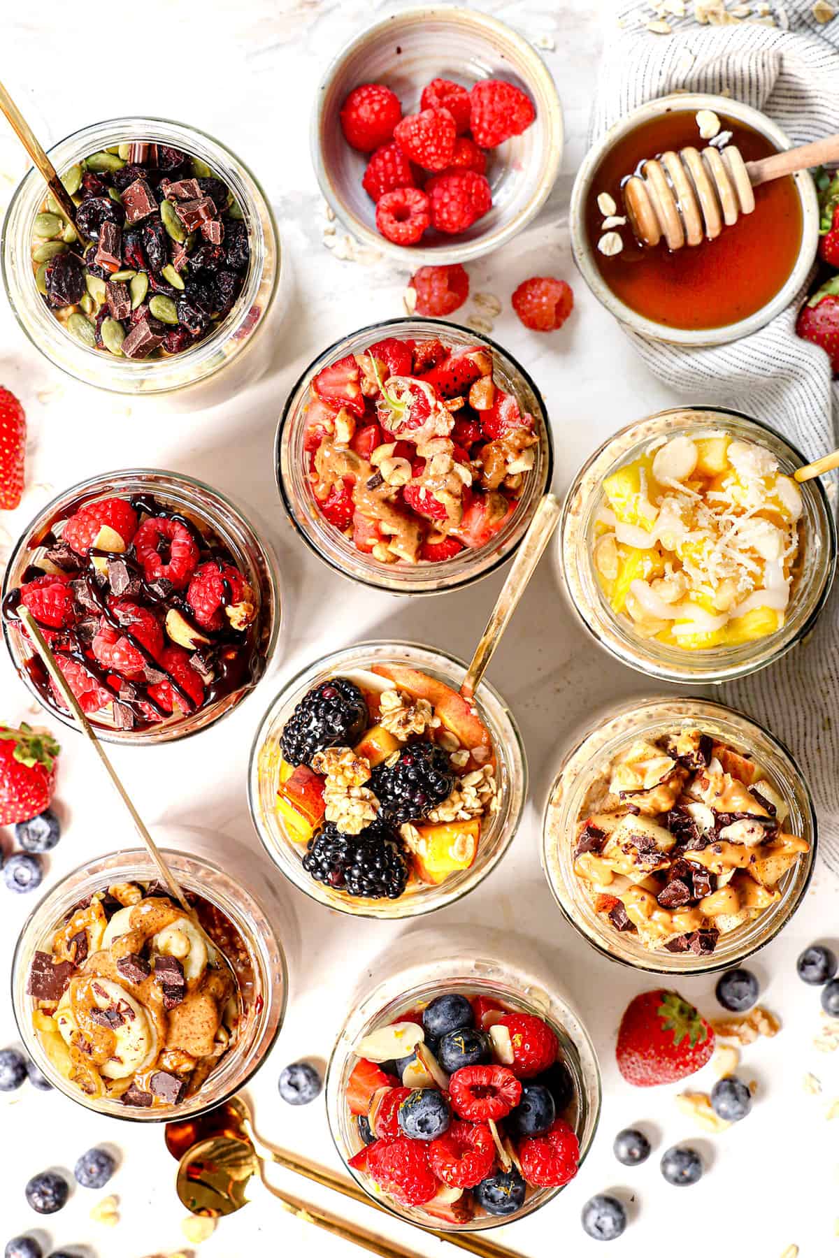 top view of overnight oatmeal recipe being served in jars nine different way