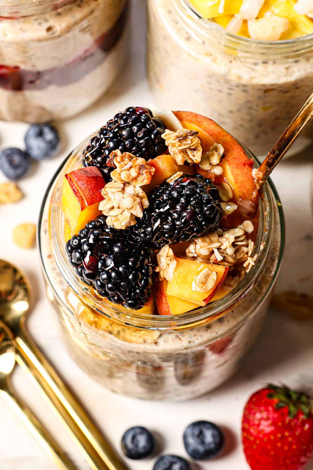 up close of recipe for overnight oats served with blackberries and peaches
