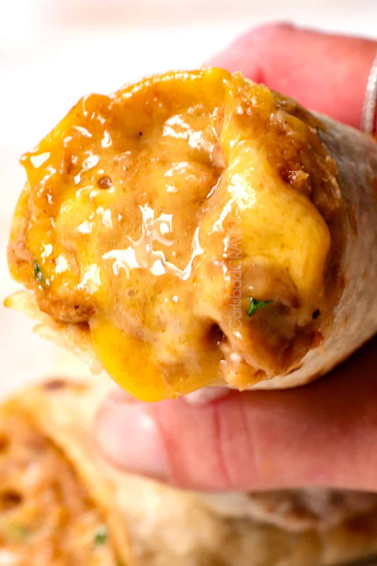 showing how to serve the best refried beans recipe in a bean and cheese burrito