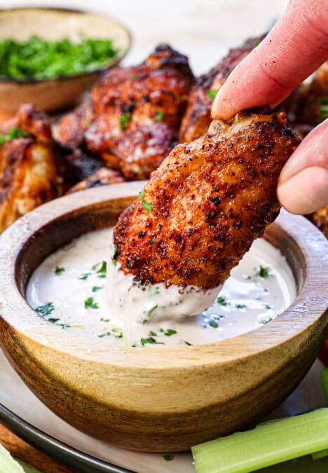 showing how to serve wings in air fryer by dipping into sauce
