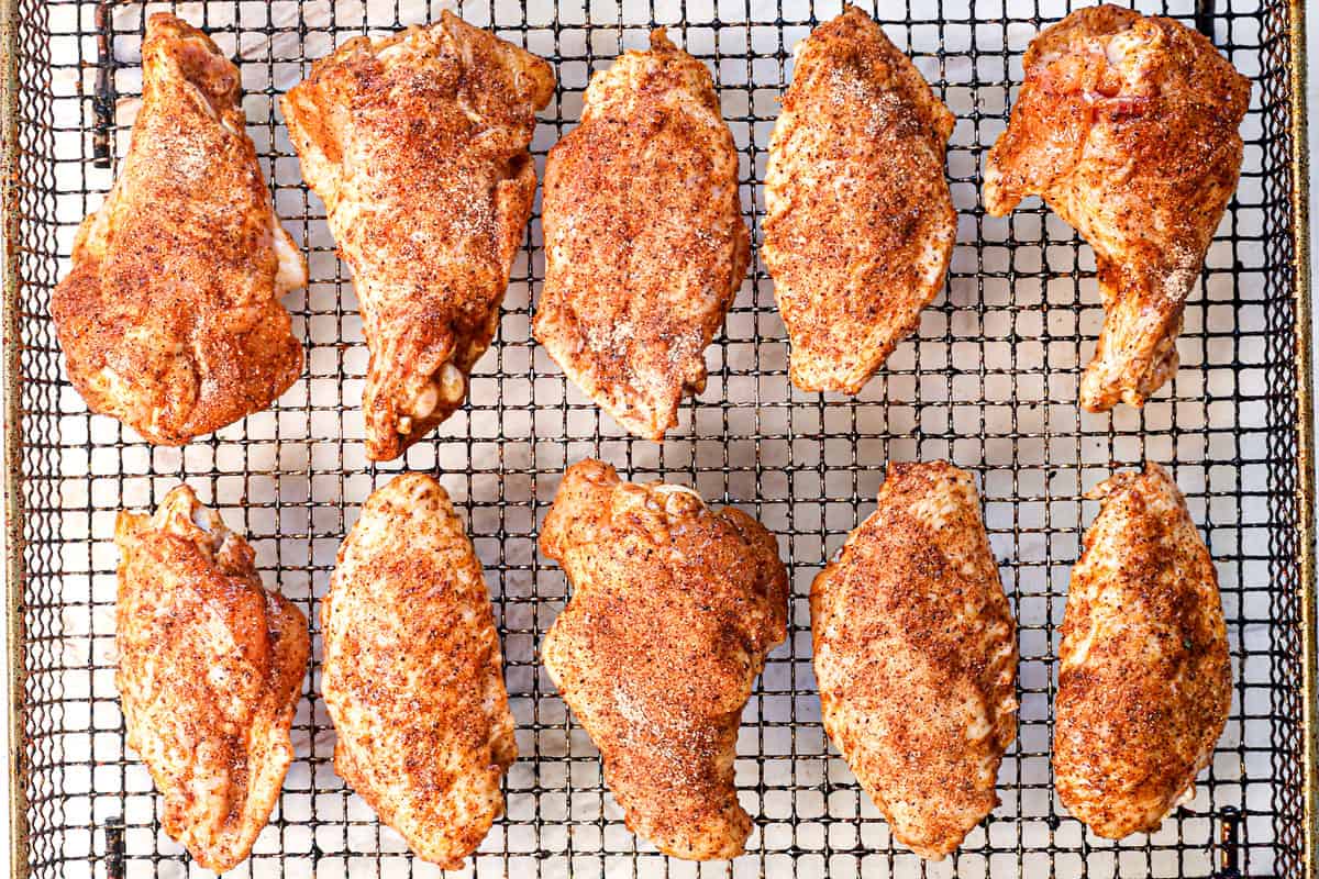 showing how to air fry chicken wings by arranging the wings in a single layer in the air fryer basket