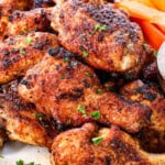 chicken wings air fryer stacked on a plate showing how crispy they are