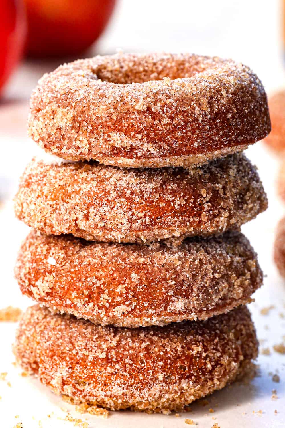 a stack of baked apple cider donuts showing how thick and fluffy they are