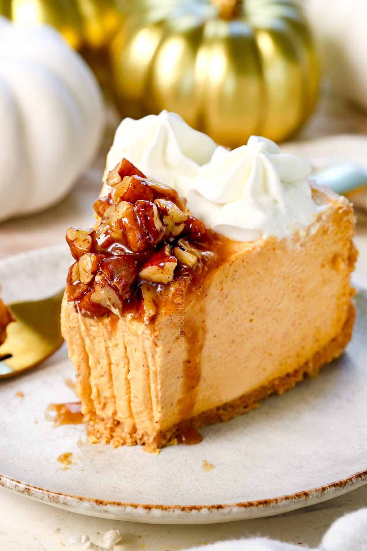 up close of No Bake Pumpkin Cheesecake with a bite taken out showing how thick and creamy it is