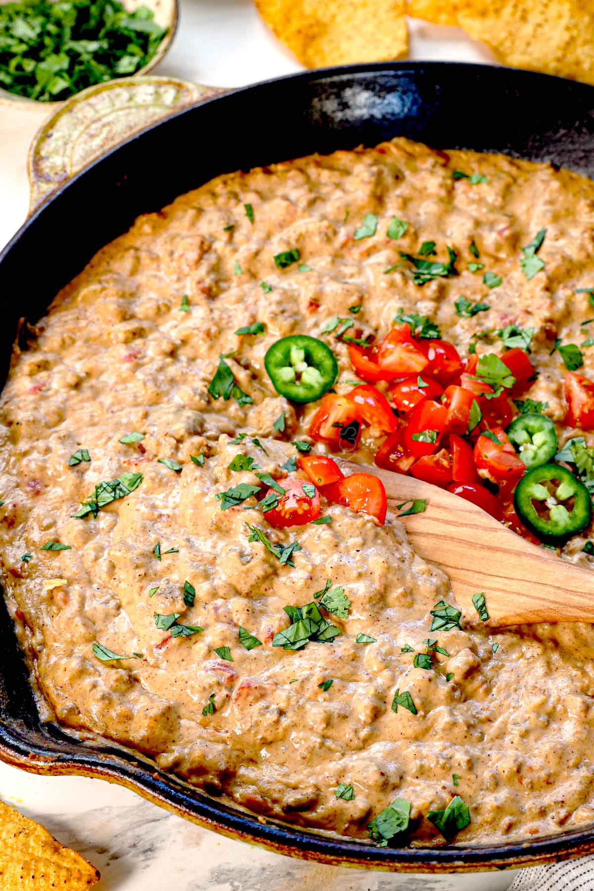 Rotel Cheese Dip being scooped with a wooden spoon showing how creamy it is
