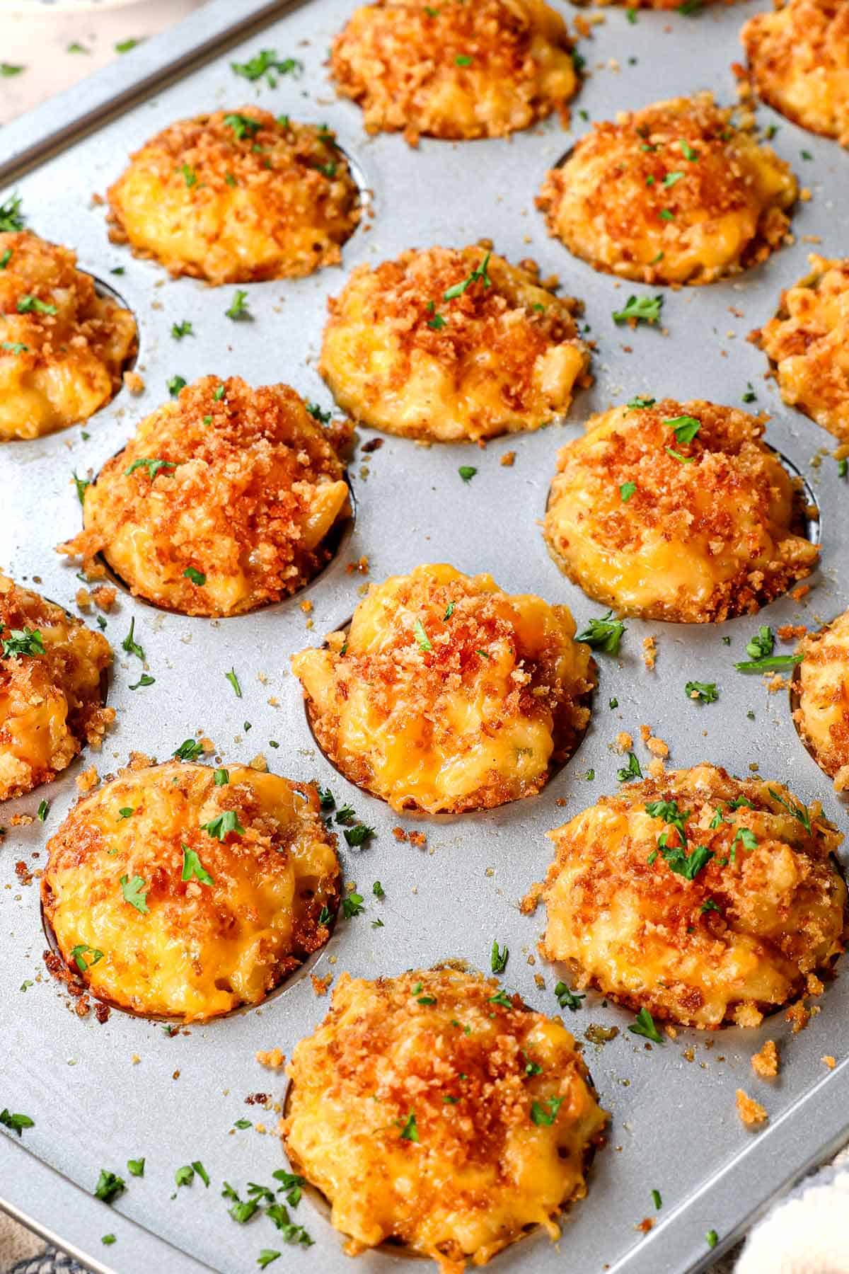 Mac and Cheese Bites recipe in a mini muffin tin tray garnished with parsley