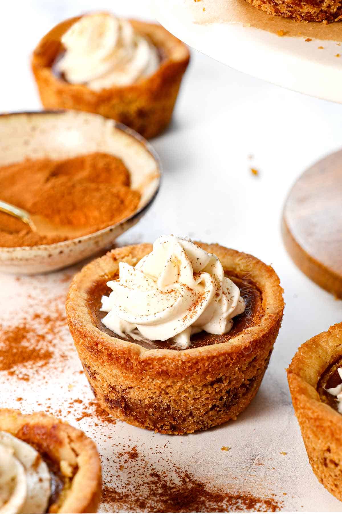 serving mini pumpkin pie garnished with cinnamon