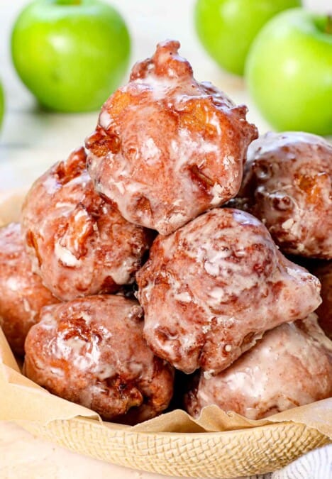 apple fritter recipe stacked on a platter with glaze