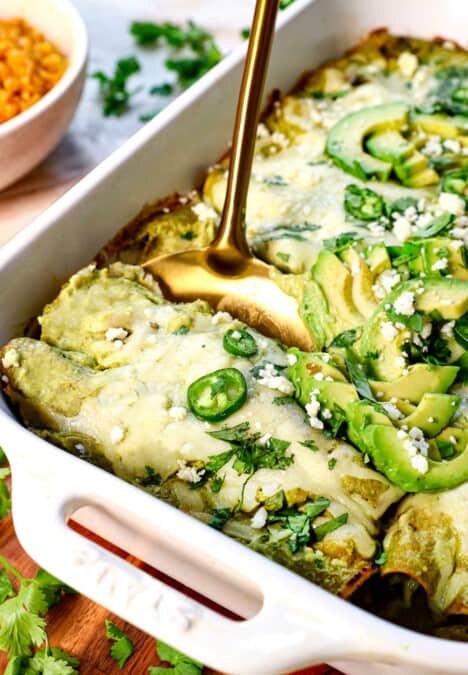up close of scooping enchilada suzias from the pan to serve