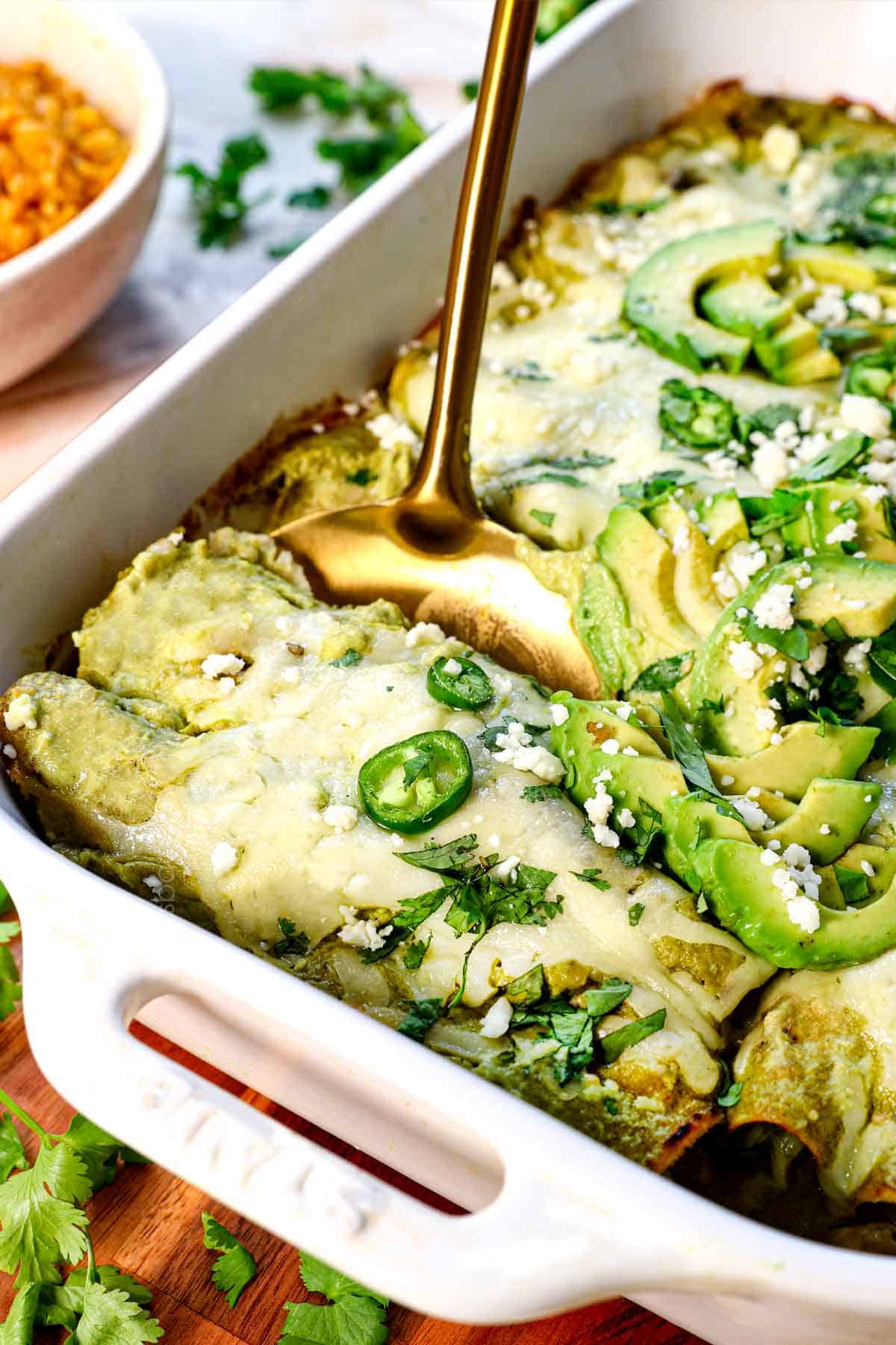 up close of scooping enchilada suzias from the pan to serve