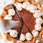 top view of chocolate chess pie recipe cut into slices topped with whipped cream
