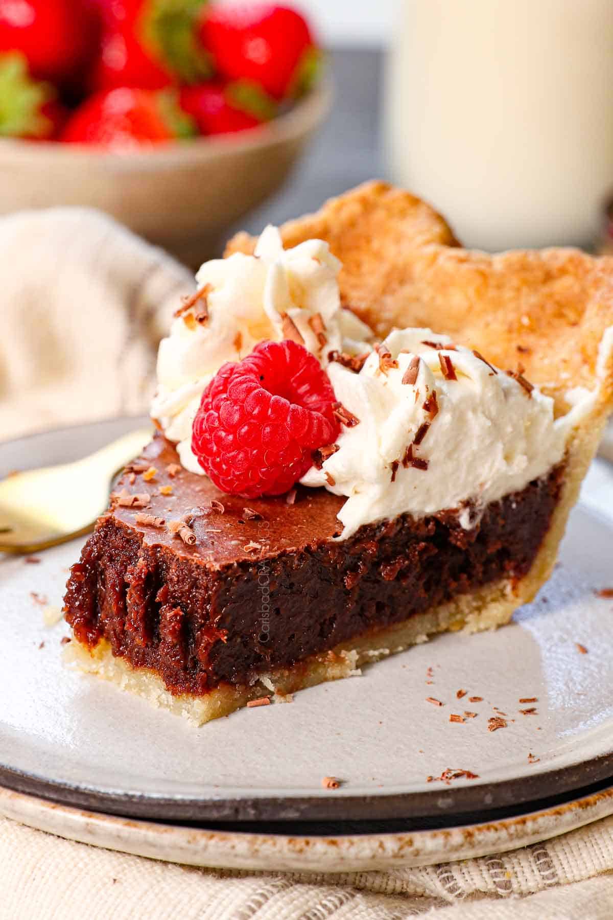 up close of a slice of chocolate chess pie with a bite taken out showing how chocolaty the custard is