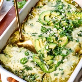 up close of scooping enchilada suzias from the pan to serve