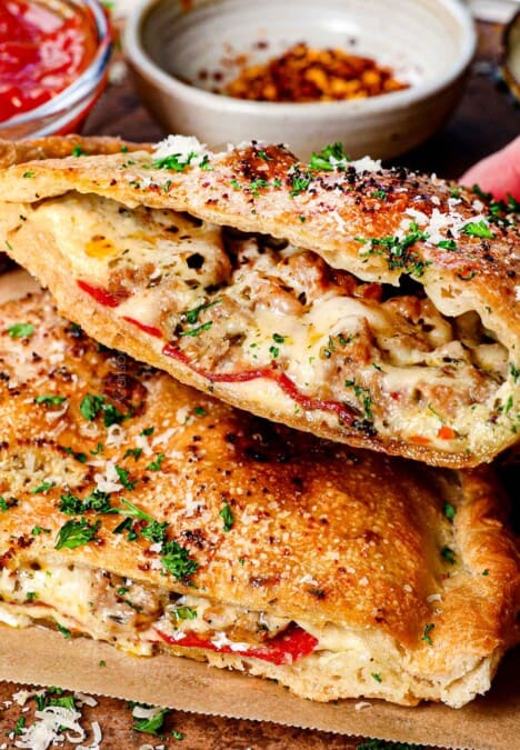 up close of holding up a bitten calzone to show the filling inside