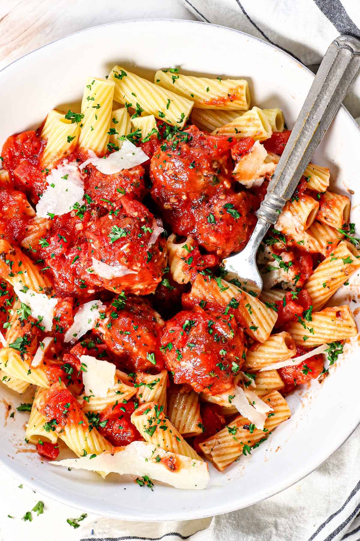 top view of chicken meatball recipe being served with tomato sauce and pasta