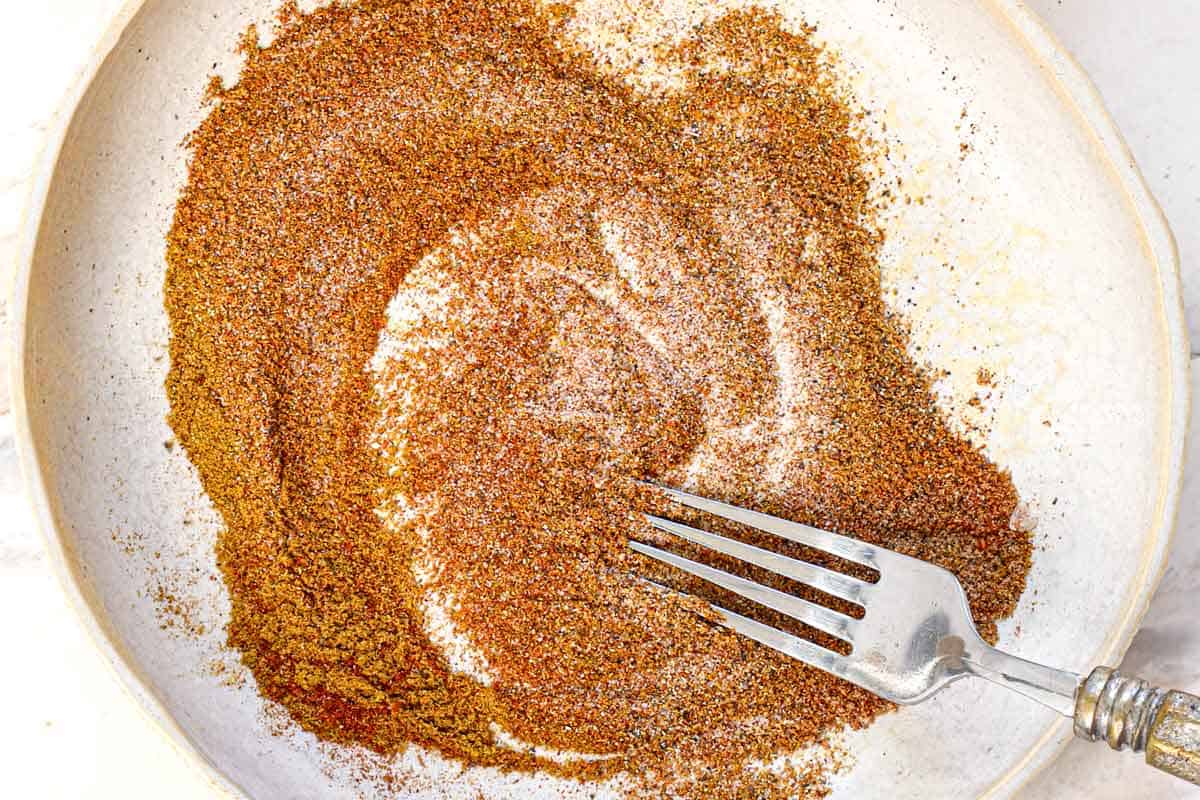 showing how to roast chickpeas by mixing the spices together in a bowl