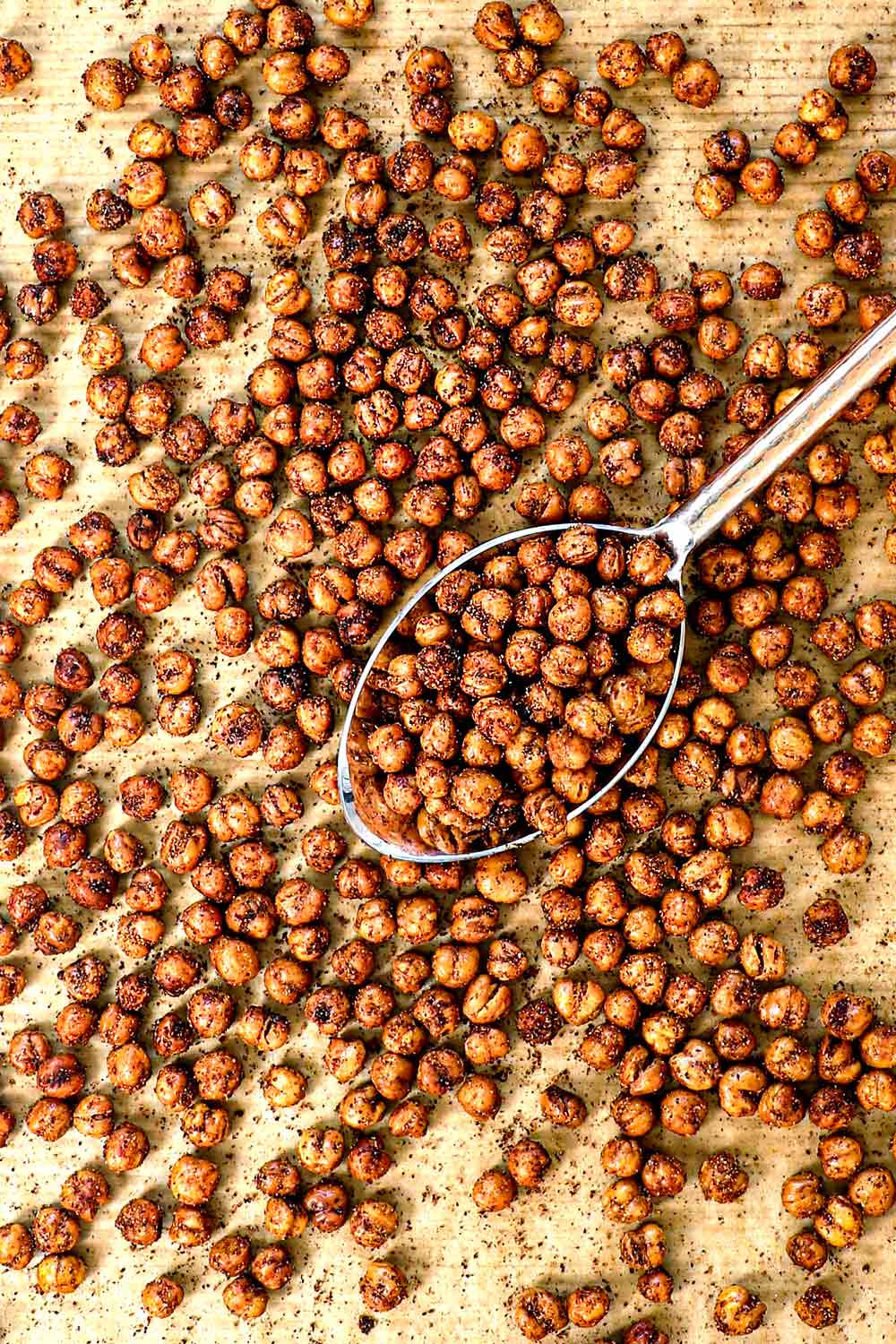 showing how to roast chickpeas by roasting in the oven on a baking sheet until crispy