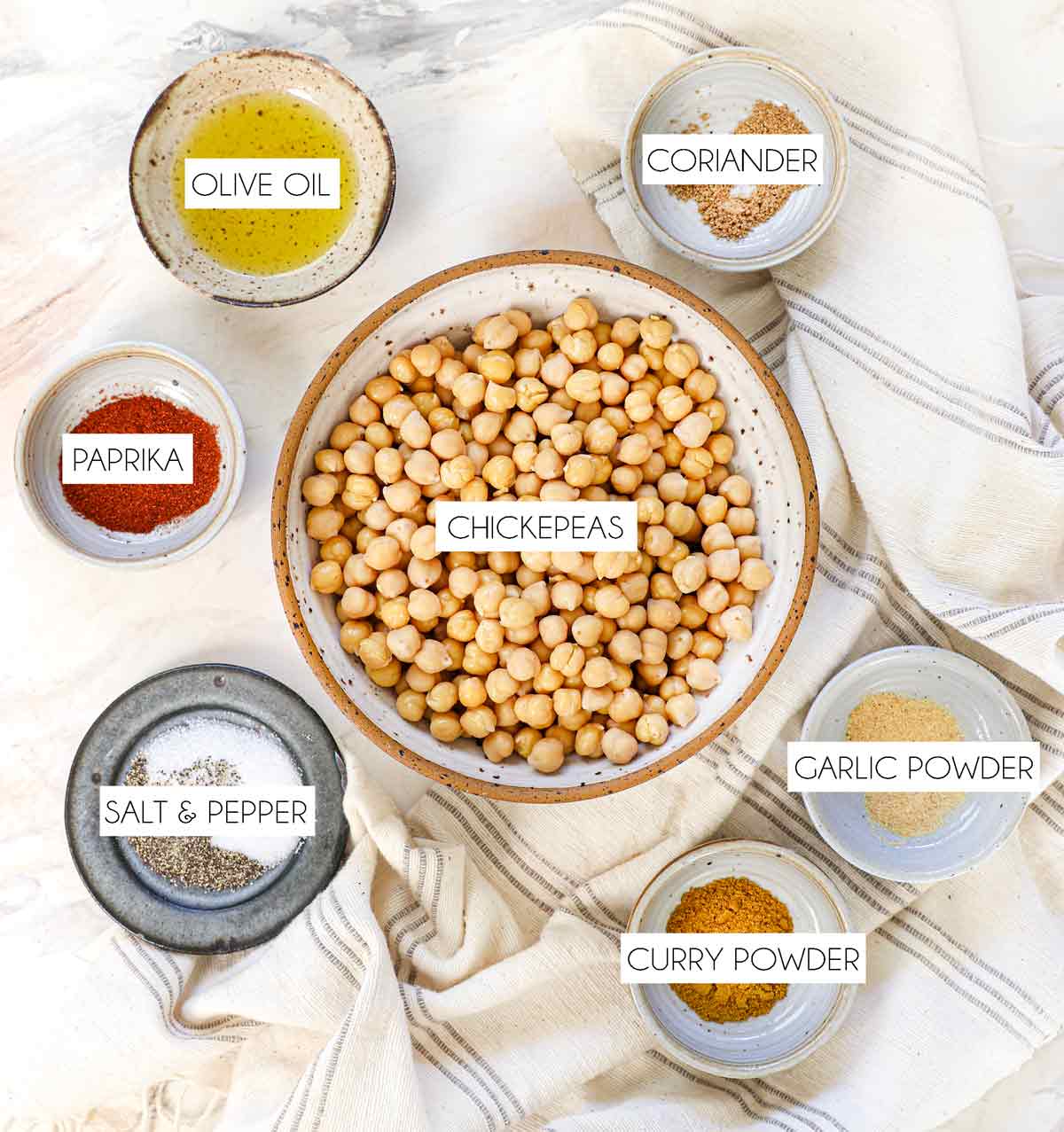 top view of roasted chickpea recipe ingredients: chickpeas, olive oil, salt, pepper, curry powder, paprika, garlic powder, ground coriander