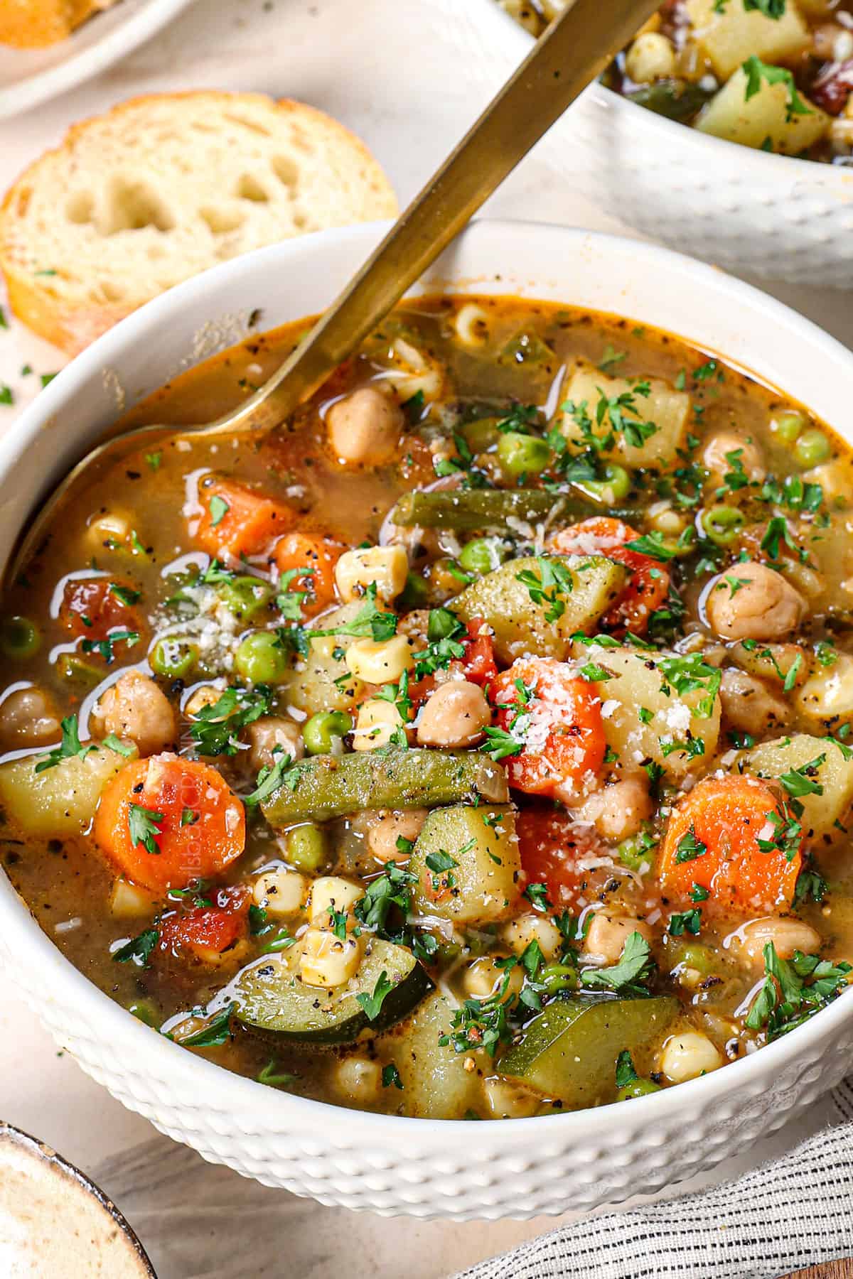 up close of easy vegetable soup being served in a bowl garnished with Parmesan
