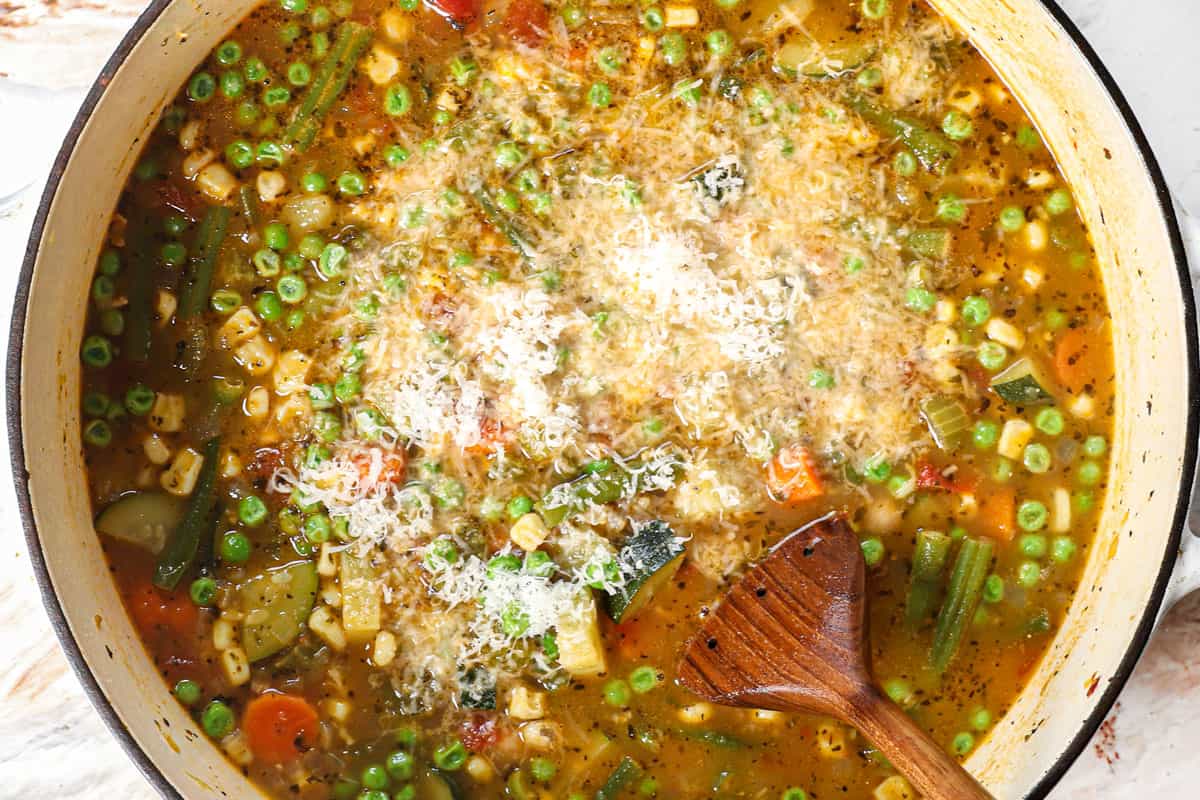 showing how to make vegetable soup by stirring in Parmesan