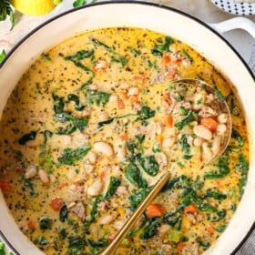showing how to make white bean soup by garnishing with parsley and Parmesan