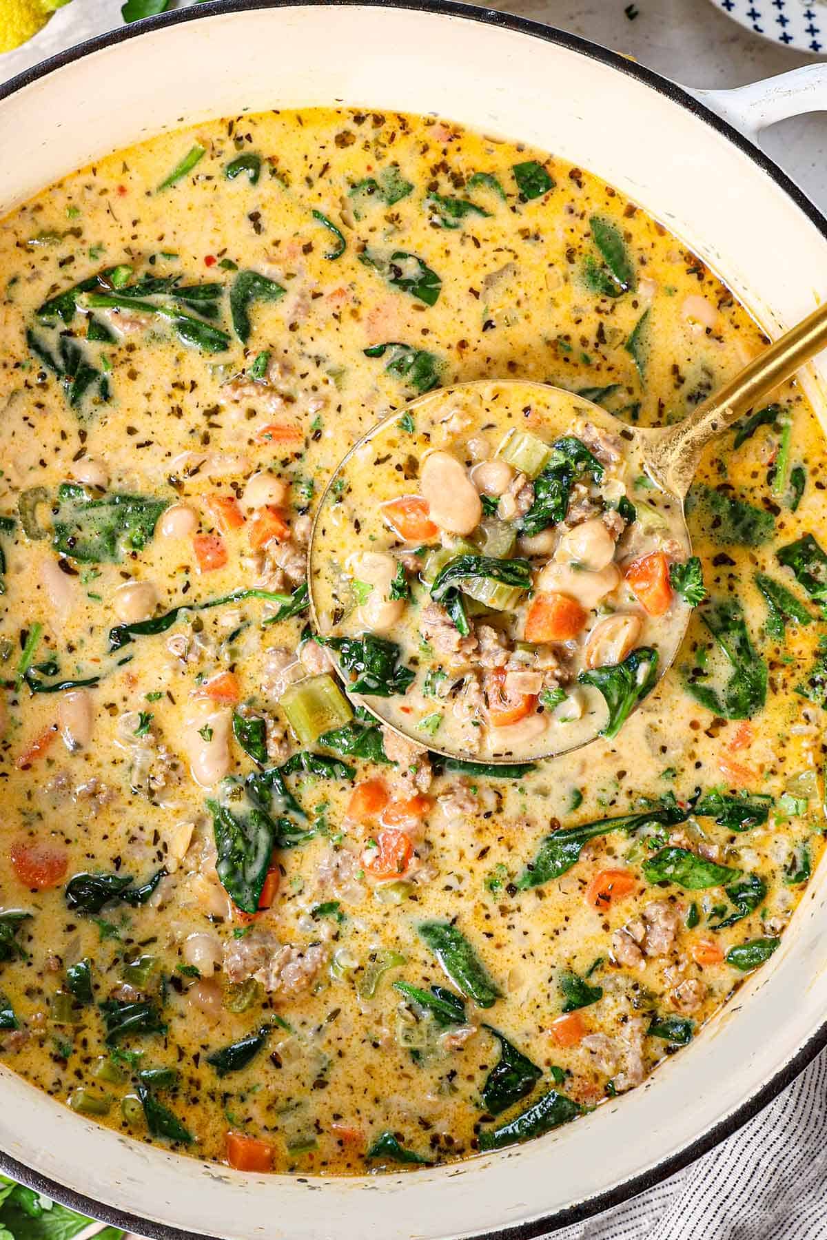 showing how to make white bean soup by garnishing with parsley and Parmesan