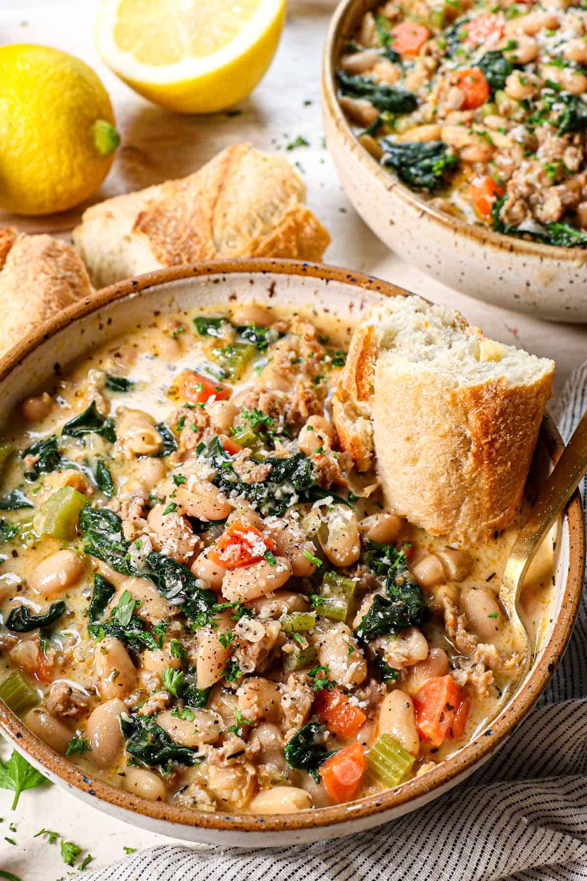 serving white bean soup in a bowl with crusty bread