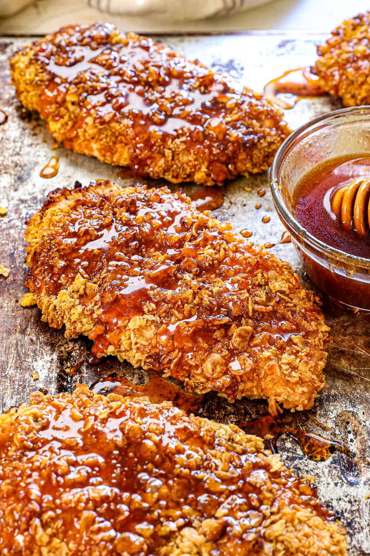 up close of honey hot chicken showing the drizzle of honey and crispy cornflakes