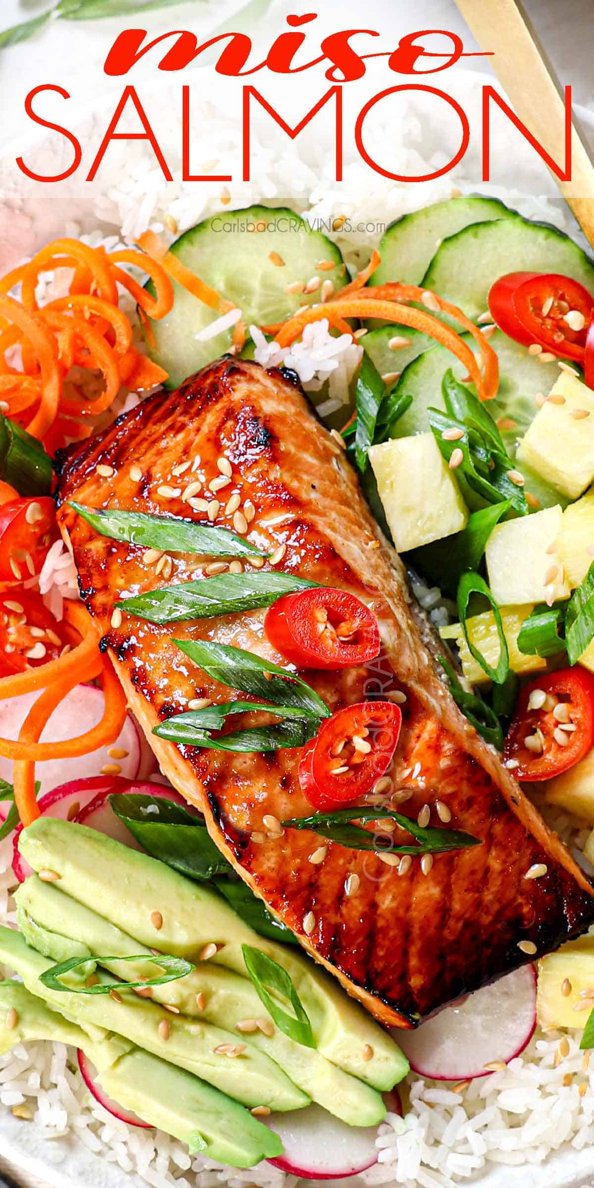 top view of miso salmon bowl with miso glazed salmon, rice. cucumbers, carrots, radishes, avocado, pineapple and chilies