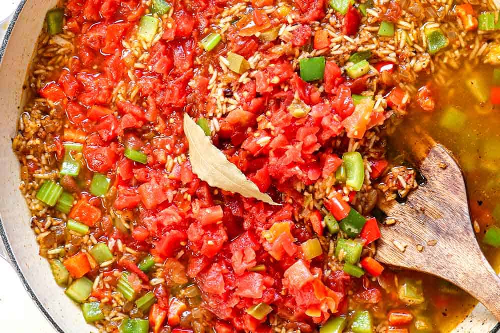 showing how to make jambalaya by adding the broth and tomatoes, then simmering