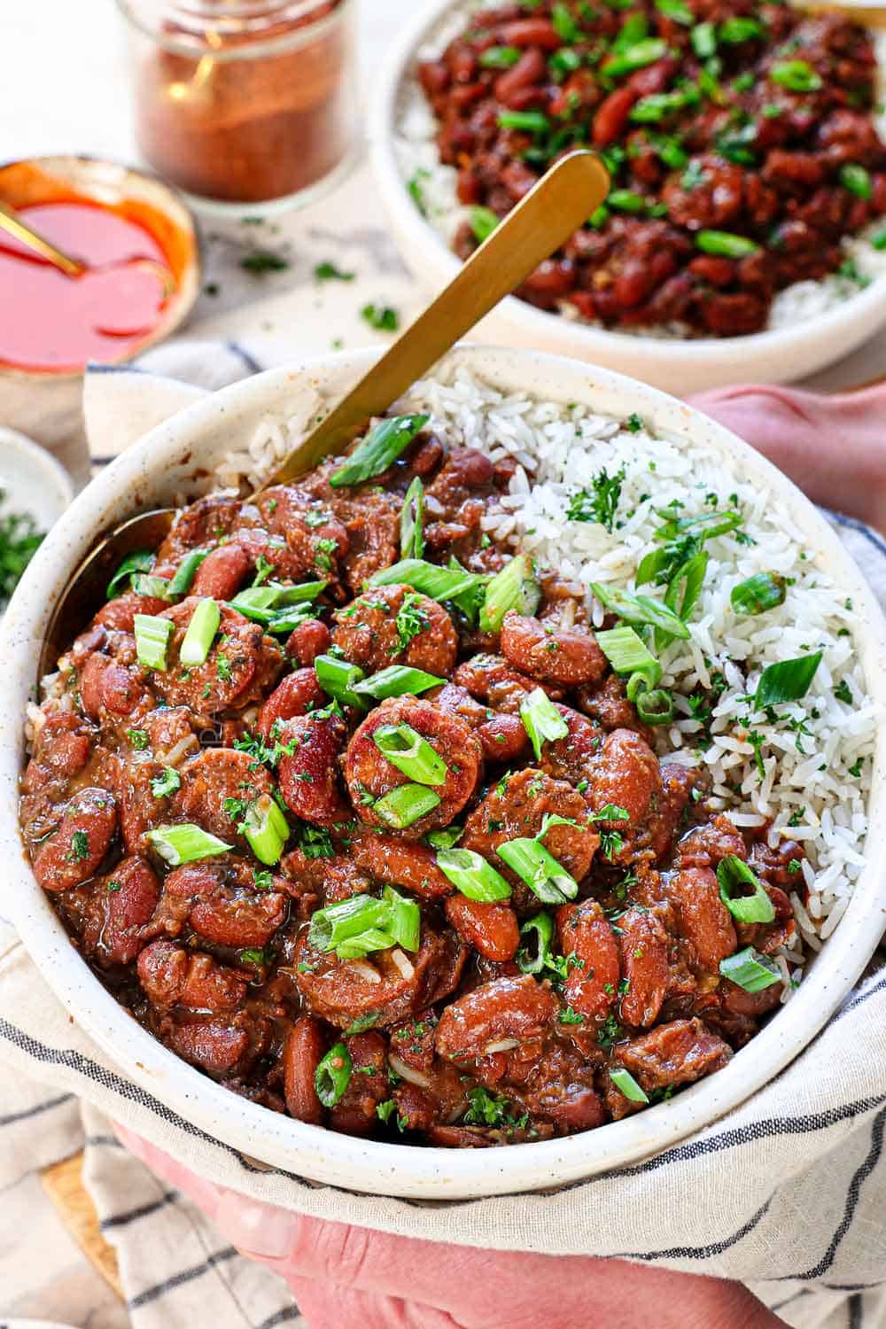 two hand holding a bowl of recipe for red beans and rice