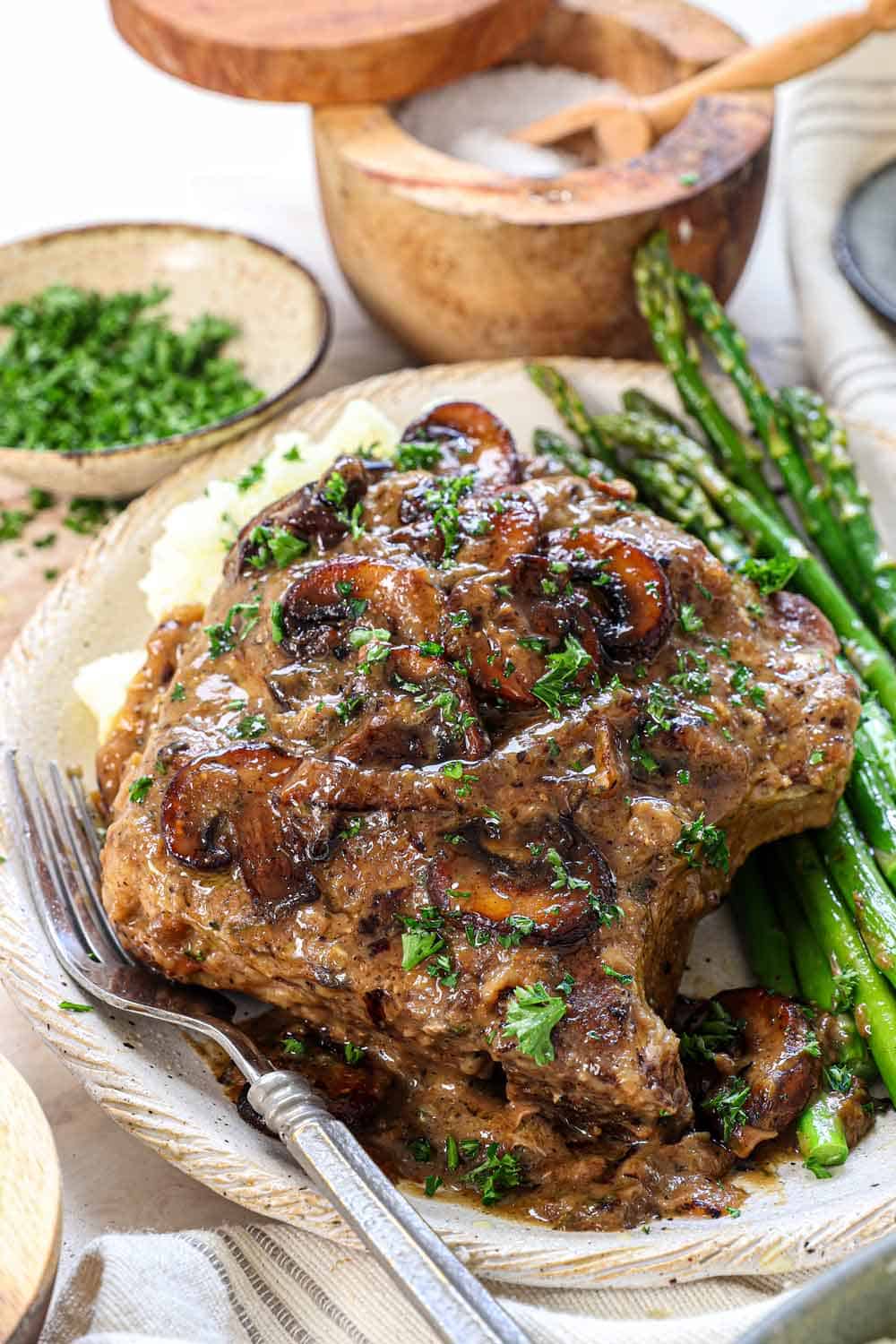 up close of smothered pork chop with mushroom gravy
