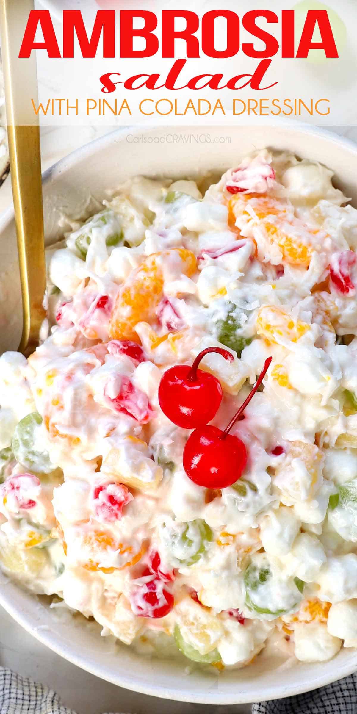 top view of ambrosia salad being served in a bowl with mandarin oranges, maraschino cherries, pineapple tidbits, grapes, marshmallows and coconut