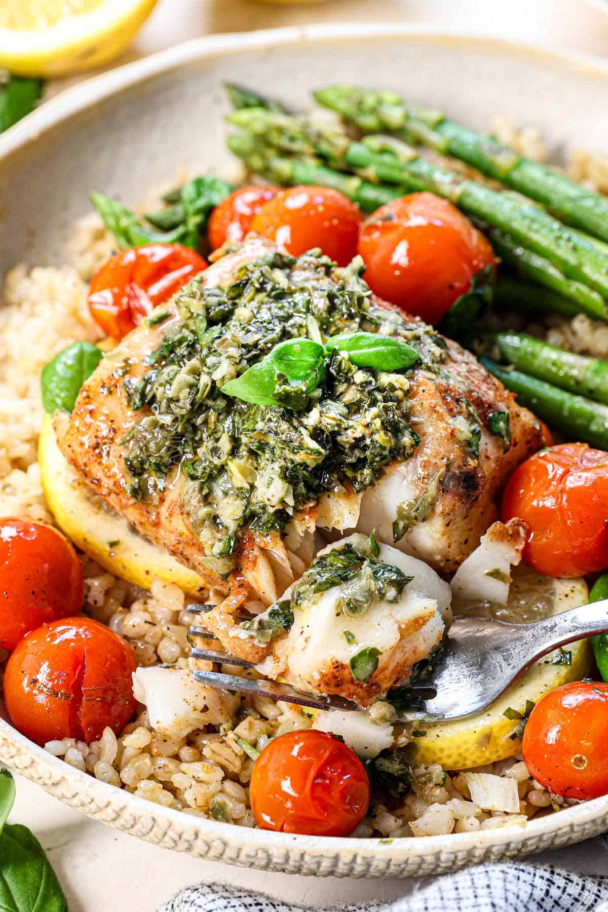 up close of best baked cod recipe ever flaking apart with a fork showing how juicy it is