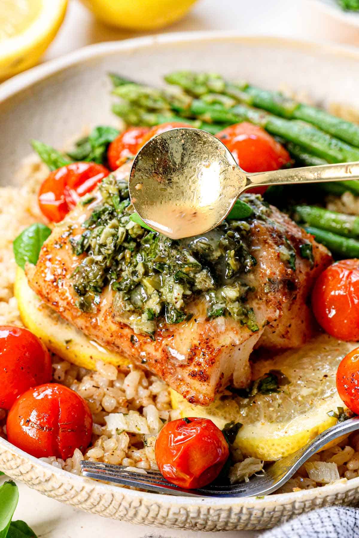 up close of drizzling the baked cod with lemon butter