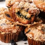 up close of best blueberry muffin recipe showing how soft and tender the muffins are and how crispy the streusel topping is