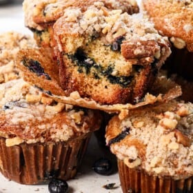 up close of best blueberry muffin recipe showing how soft and tender the muffins are and how crispy the streusel topping is