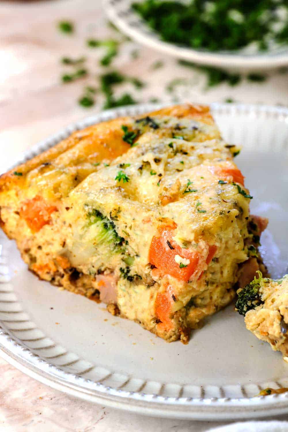 up close of a slice of best crustless quiche recipe showing how creamy and cheesy it is