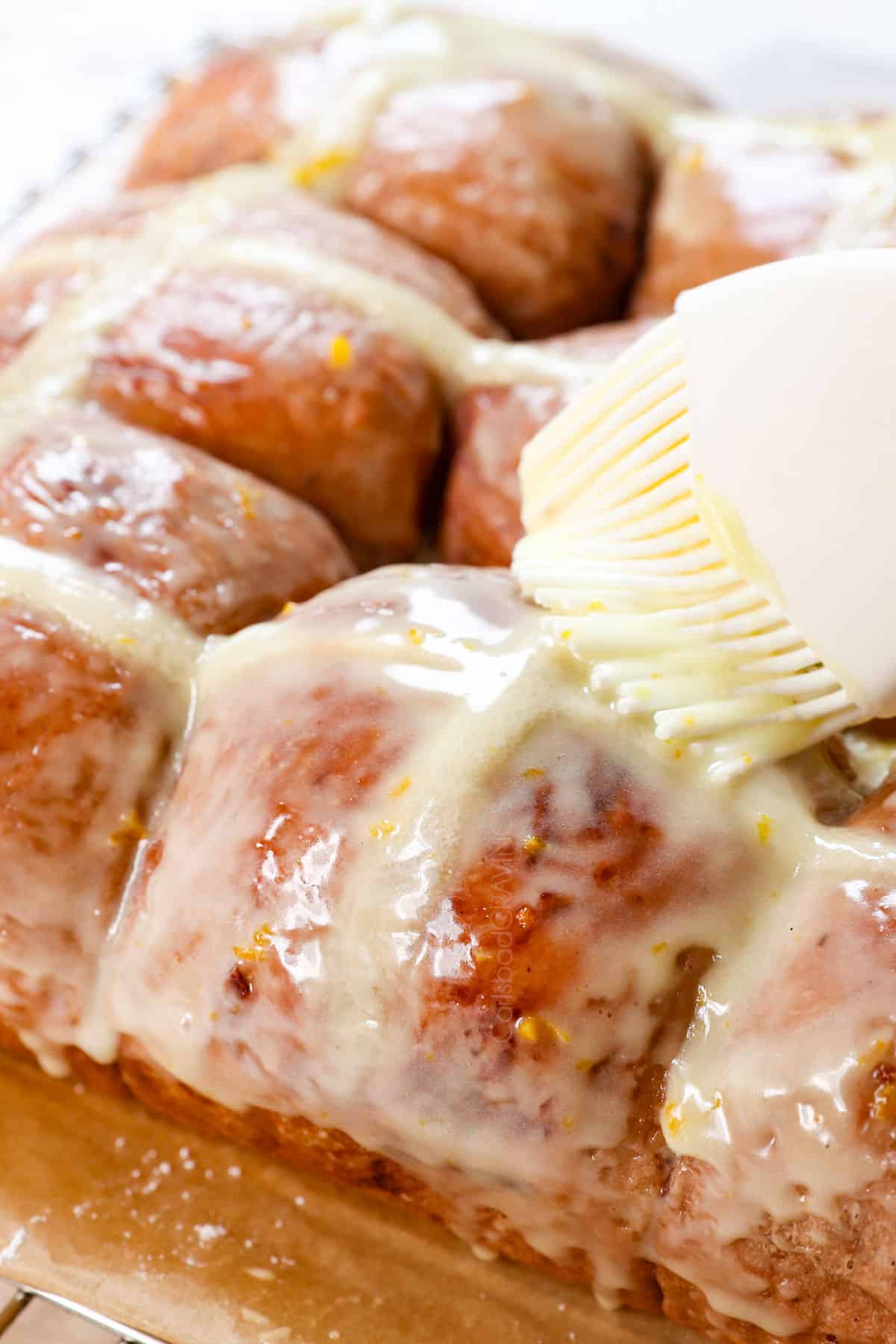 brushing a glaze over hot cross buns recipe