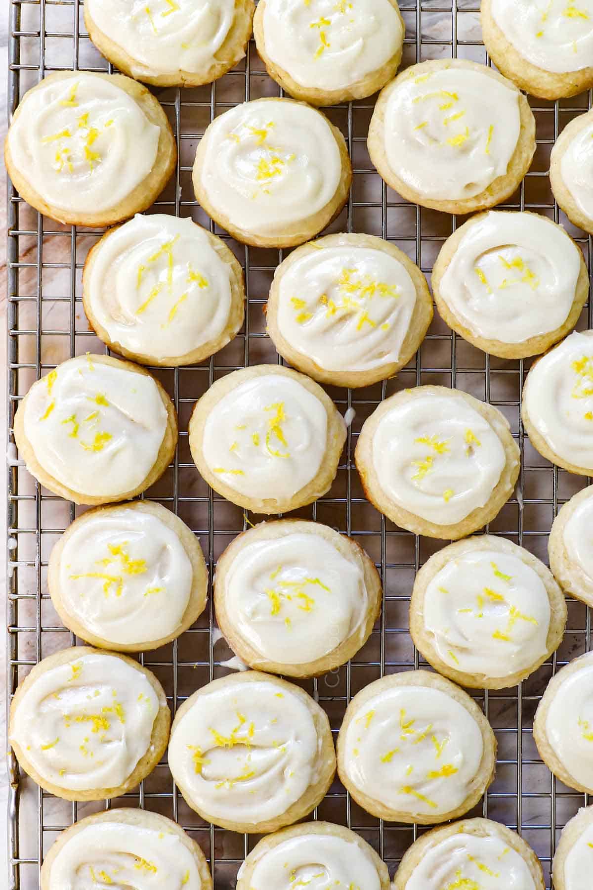 showing how to make lemon cookies by topping with lemon glaze