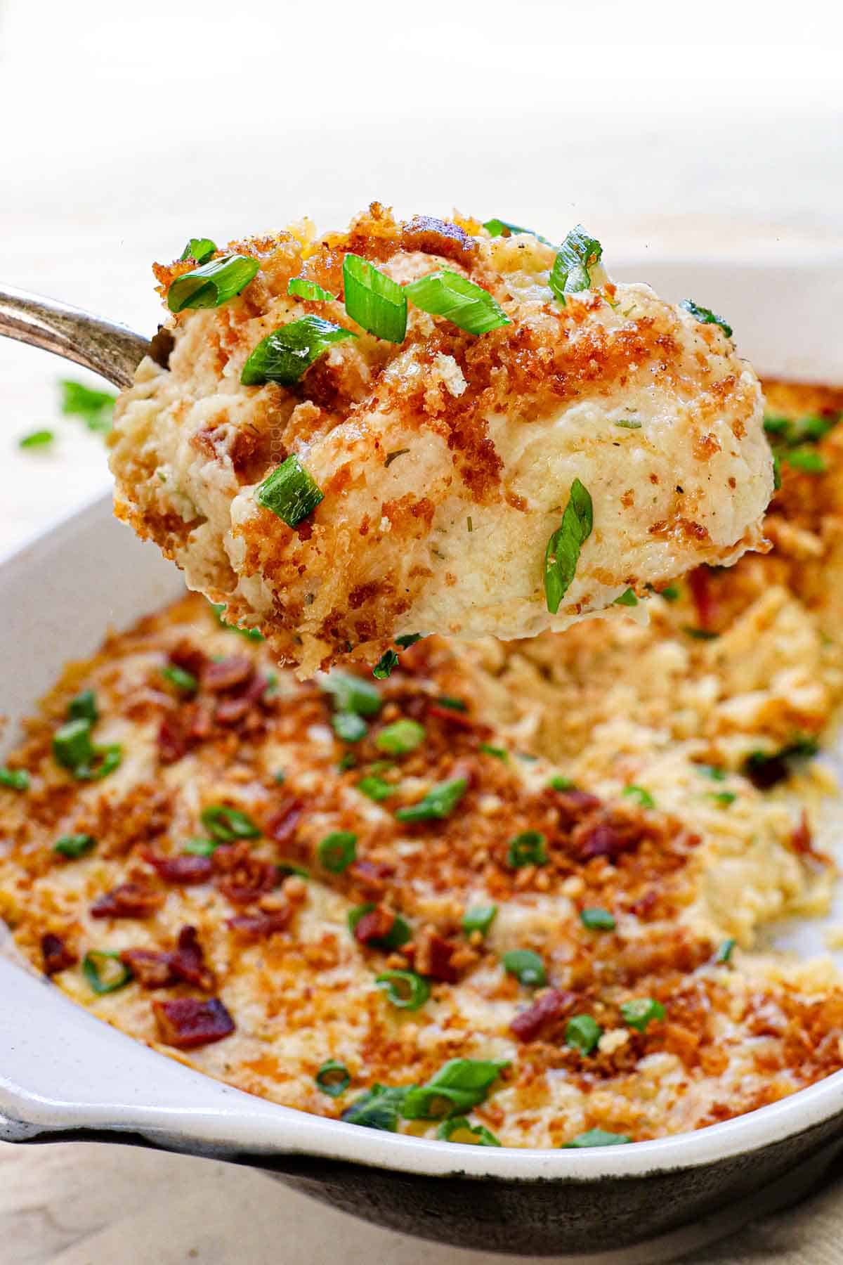 a scoop of baked mashed potatoes with panko topping